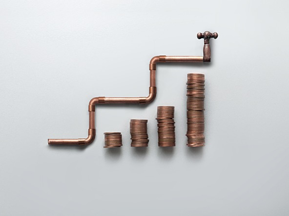 heating pipe and coins - concept of high cost of living and rising energy prices